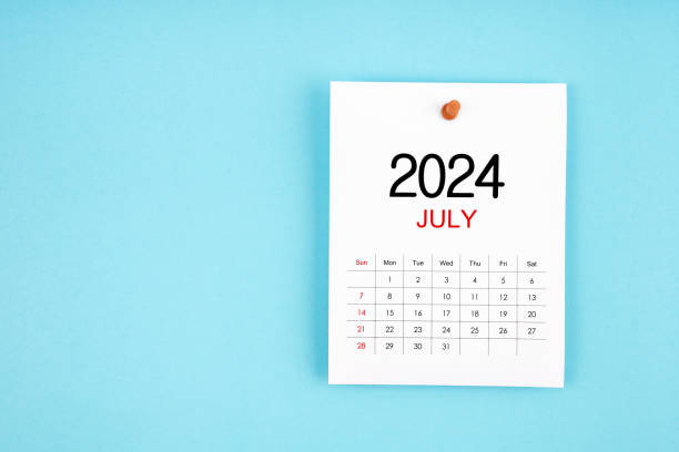 istock July 2024 calendar page with push pin on blue background. 2148385277