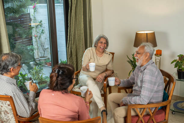 Old friends enjoying tea party together at home