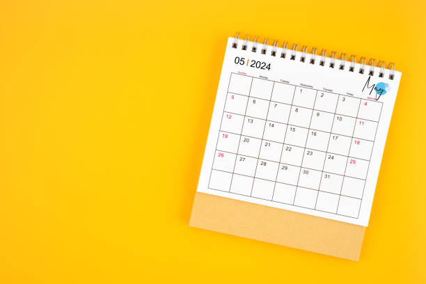 istock May 2024 desk calendar on yellow color background. 2148385426