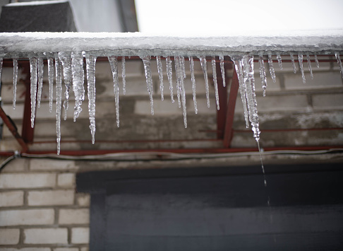Beautiful sharp icicles from the eaves of the roof