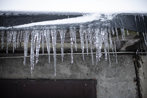 Beautiful sharp icicles from the eaves of the roof