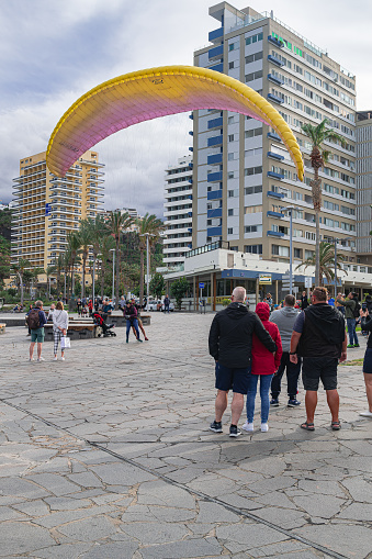 Puerto de la Cruz, Tenerife; January 30 2023: tandem paraglider landing at the Martianez fountains, in Puerto de la Cruz, Tenerife, Canary islands