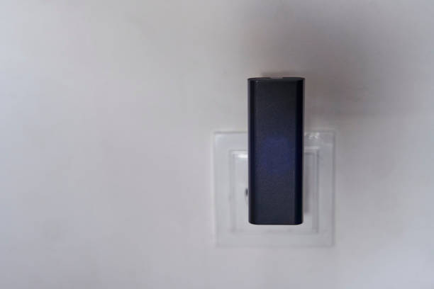 istock A black wi-fi router is connected to a white outlet on a white wall 2148386188