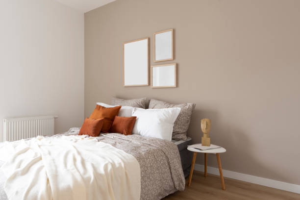 istock Bed in interior bedroom with bedclothes and pillow in orange with blank frame on the wall. 2148386701
