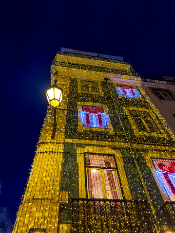 Typical Portuguese building in downtown Lisbon, decorated with Christmas lights.