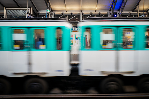Paris, France - April 8th, 2024: Speeding subway at the metro station Bir-Hakeim near by the Eifel tower.