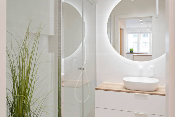 istock Home interior of modern bathroom with ceramic sink, bath shower and circle mirror. Elegance and luxury in apartment. 2148387521