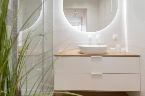 istock Home interior of modern bathroom with ceramic sink, bath shower and circle mirror. Elegance and luxury in apartment. 2148387530