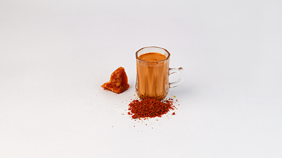 Jaggery Tea on white background with jaggery, Pune, Maharashtra, India