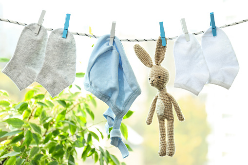 Child clothes and toy hanging on twine