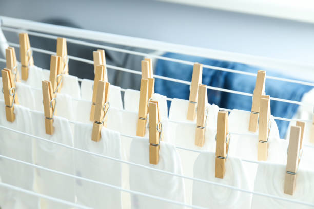 Wooden clothespins with white socks on the dryer