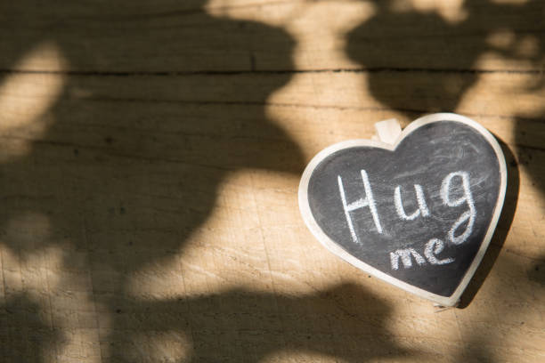istock Hug me hand drawing phrase on a heart, Sharing a Hug concept 2148388706