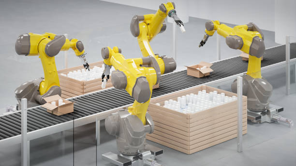 istock Robots at a conveyor belt packing items into cardboard packages. 2148388843