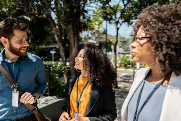 istock Coworkers talking while walking in the street 2148389164