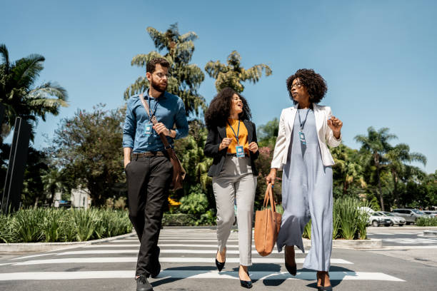 istock Coworkers talking while walking in the street 2148389187