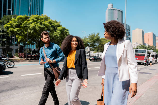 istock Coworkers talking while walking in the street 2148389295
