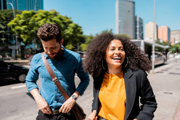 istock Coworkers talking while walking in the street 2148389305
