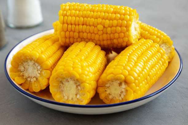istock Homemade Steamed Corn on the Cob with Butter on a Plate, side view. Close-up. 2148389820