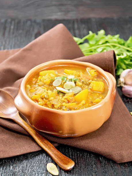 istock Soup-curry with pumpkin and lentils in bowl on black board 2148391647