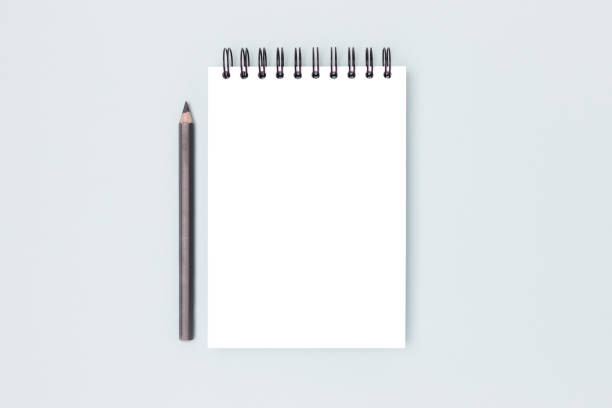 istock Blank notepad mock up and pencil on a blue background. 2148392219