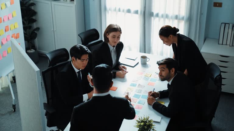 Top view of manager pointing whiteboard while planning strategy. Directorate.