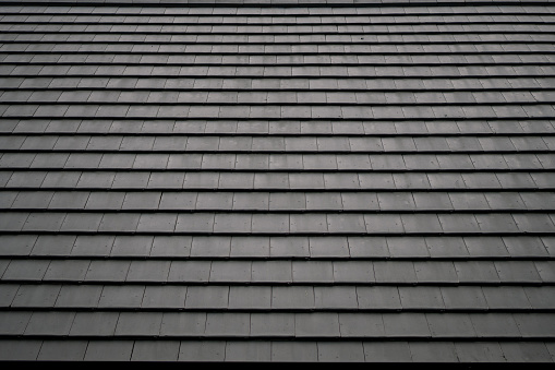 Pattern of black square-shaped roof tiles. Abstract