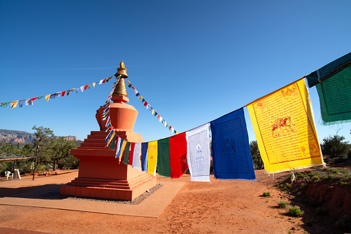 Colorful, prayer flags flapping in the wind at the Amitabha Stupa Peace park in Sedona Arizona