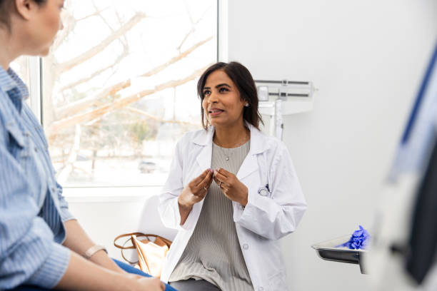 istock Female doctor gestures while talking to her patient 2148393466