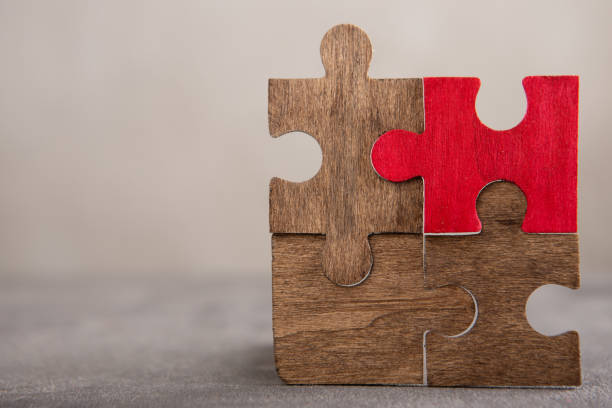 istock Creative idea and solve the problem concept. Teamwork success strategy - wooden puzzle on the grey background 2148393826