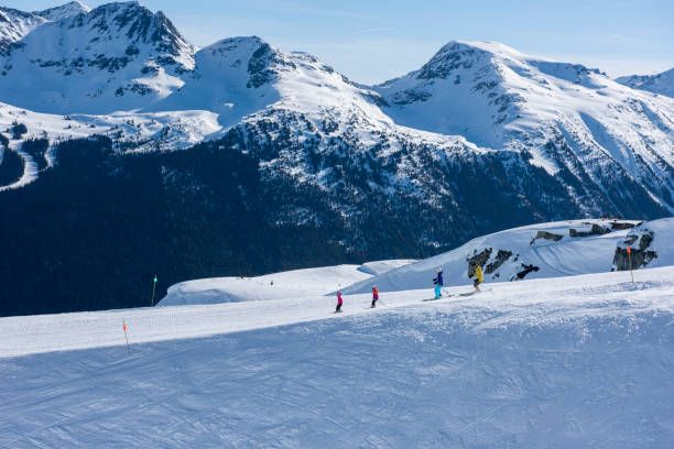 istock Family skis down slope at ski resort 2148397054