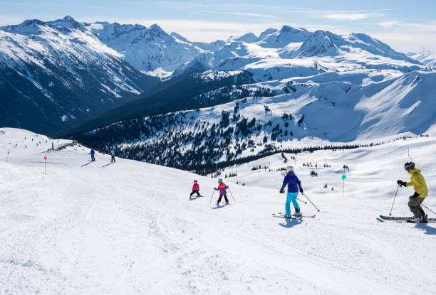 istock Family skis down slope at ski resort 2148397056