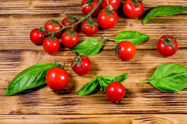 Heap of small cherry tomatoes on rustic wooden table