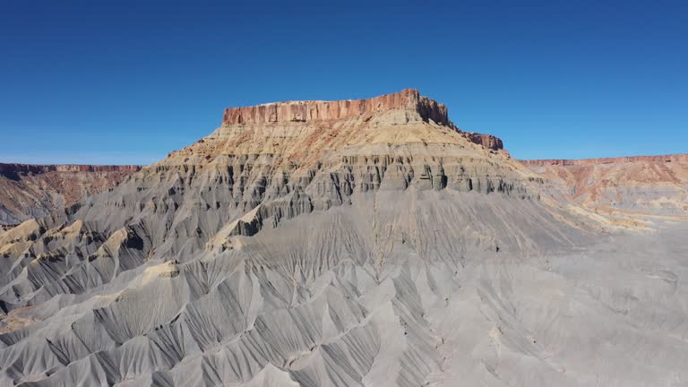 Valley Of Hills With Mountain Ranges Of Steel Blue Mudstone In Canyon Butte