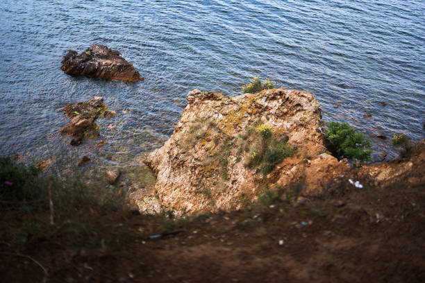 a rock in the Mediterranean Sea is covered with clay