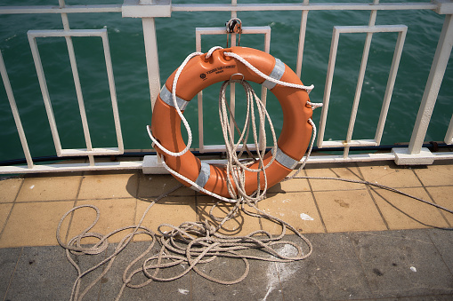 a lifebuoy with a rope on the pier