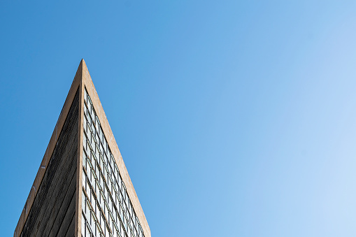 Building detail on cloudless blue sky background. Horizontal. Advertising space.