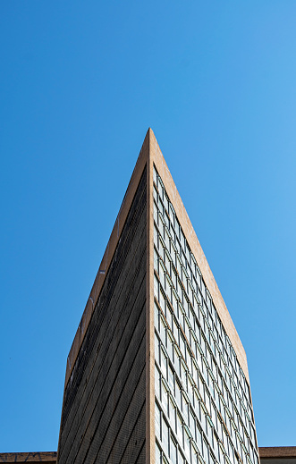 Building detail on cloudless blue sky background. Vertical. Advertising space.