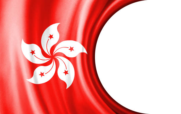 Flag of Hong Kong waving on pole, bright sun in the blue summer sky on the background
