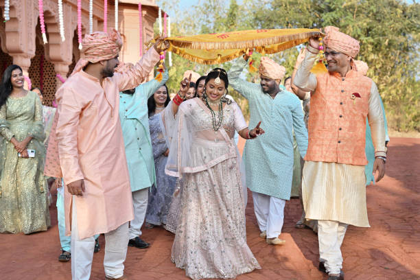 istock Dancing entry of a bridal under the Phoolon Ka Chadar (Floral canopy) with relatives 2148402007