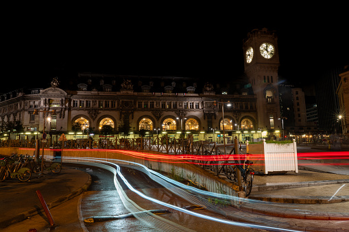 Facade of the Paris-Lyon train station with the lights of the cars passing in front of them. Paris. France. August 11, 2023