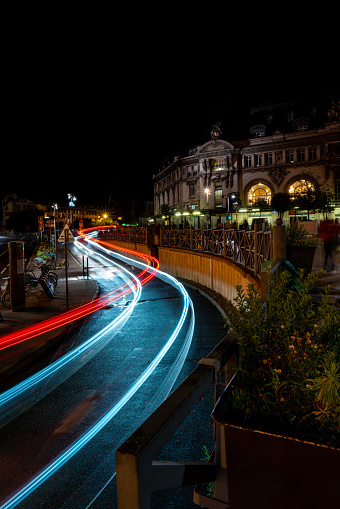 Low exposure photo of the lights of a car leaving the Paris-Lyon station at night. Paris. France. August 11, 2023