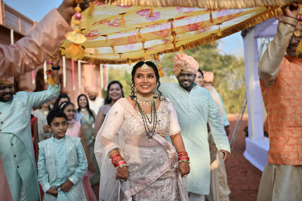 istock Smiling bride entering the wedding venue along with relatives 2148402069