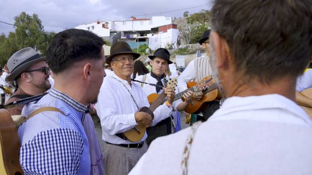 El Pajar, Gran Canaria, Canary Islands, Spain - April 6, 2024 - Romeria de Santa Agueda - Man with traditional clothes playing the Timble, typical Canarian instrument