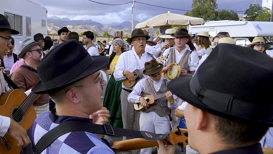 El Pajar, Gran Canaria, Canary Islands, Spain - April 6, 2024 - Romeria de Santa Agueda - Children, young people and adults with traditional clothes playing and singing on the street
