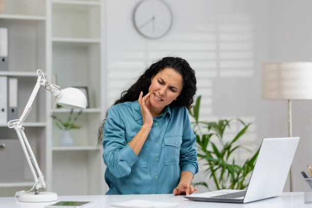 istock Businesswoman feeling tooth pain while working in office 2148403213
