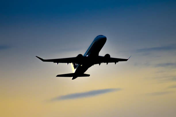 istock Silhouette of a passenger jetliner taking off at dusk. 2148403396