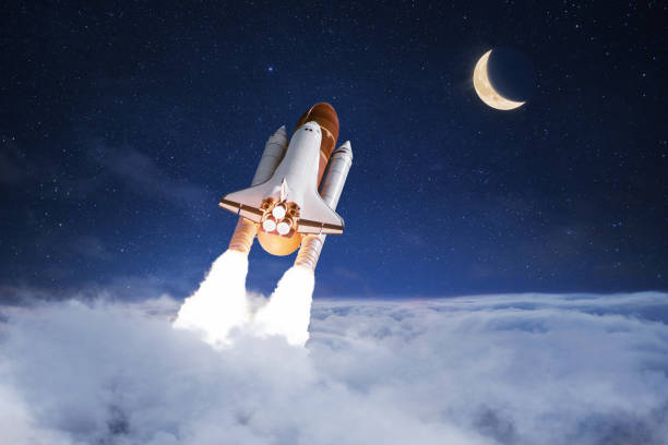 istock Space shuttle rocket successfully takes off through the clouds towards the moon in the starry sky, creative idea. Journey to the moon, concept. Rocket lift off and launch 2148403759