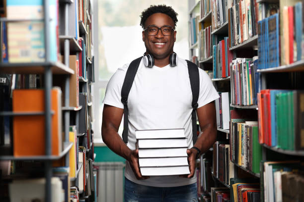 istock Young black man buying new interesting books in bookstore 2148405996