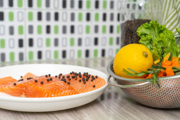 Fresh salmon fish with pepper and fresh vegetable preparing to cooking.