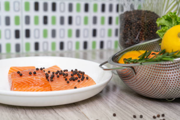 Fresh salmon fish with pepper and fresh vegetable preparing to cooking.